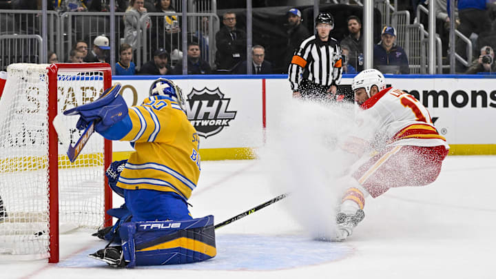Jan 10, 2023; St. Louis, Missouri, USA;  Calgary Flames left wing Milan Lucic (17) scores against St. Louis Blues goaltender Jordan Binnington (50) during the first period at Enterprise Center. Mandatory Credit: Jeff Curry-Imagn Images