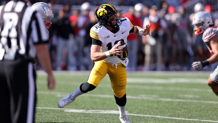 Oct 5, 2024; Columbus, Ohio, USA;  Iowa Hawkeyes quarterback Cade McNamara (12) drops back to throw against the Ohio State Buckeyes during the first quarter at Ohio Stadium. Mandatory Credit: Joseph Maiorana-Imagn Images