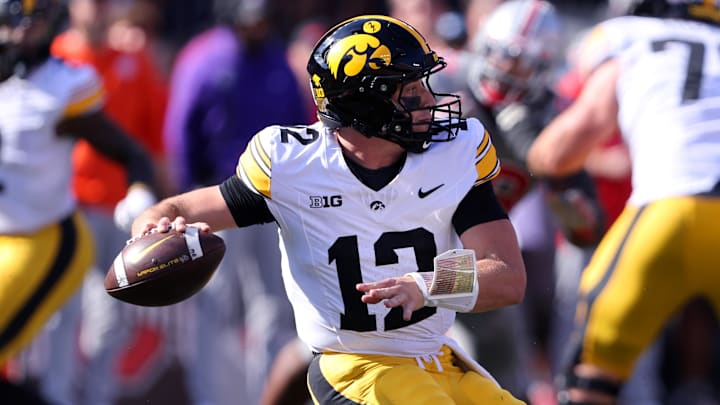 Oct 5, 2024; Columbus, Ohio, USA;  Iowa Hawkeyes quarterback Cade McNamara (12) drops back against the Ohio State Buckeyes to throw during the first quarter at Ohio Stadium.