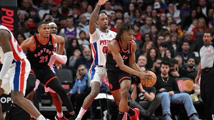Apr 4, 2025; Toronto, Ontario, CAN;  Toronto Raptors guard Ja'Kobe Walter (14) controls the ball in front of Detroit Pistons forward Ron Halland II (00) in the first half at Scotiabank Arena. Mandatory Credit: Dan Hamilton-Imagn Images