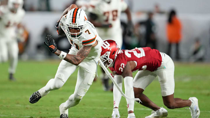 Jan 19, 2026; Miami Gardens, FL, USA; Miami Hurricanes wide receiver CJ Daniels (7) runs with the ball against Indiana Hoosiers defensive back Jamari Sharpe (22) during the second half of the College Football Playoff National Championship game at Hard Rock Stadium. Mandatory Credit: Kirby Lee-Imagn Images