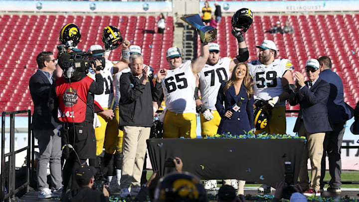 Dec 31, 2025; Tampa, FL, USA; Iowa Hawkeyes head coach Kirk Ferentz lineman Logan Jones (65) and offensive lineman Beau Stephens (70) react after beating the Vanderbilt Commodores in the ReliaQuest Bowl at Raymond James Stadium. Mandatory Credit: Nathan Ray Seebeck-Imagn Images
