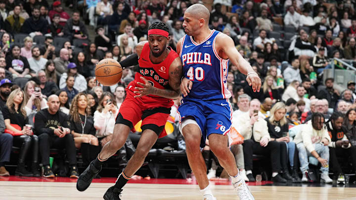 Mar 31, 2024; Toronto, Ontario, CAN; Toronto Raptors forward Jalen McDaniels (2) controls the ball as Philadelphia 76ers forward Nicolas Batum (40) tries to defend during the fourth quarter at Scotiabank Arena. Mandatory Credit: Nick Turchiaro-USA TODAY Sports