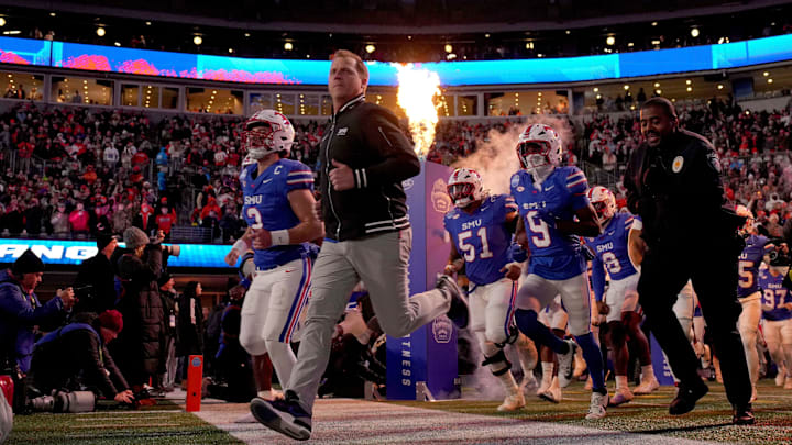 Southern Methodist Mustangs head coach Rhett Lashlee leads his team to the field before the 2024 ACC Championship game against the Clemson Tigers at Bank of America Stadium. 