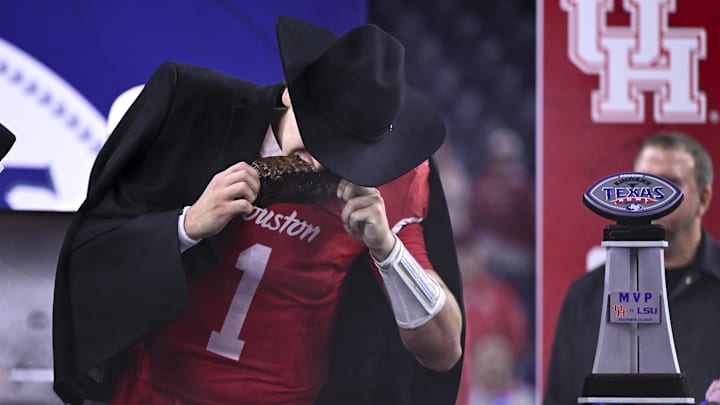 Dec 27, 2025; Houston, TX, USA; Houston Cougars quarterback Conner Weigman (1) takes a bite of barbecue after the win over Louisiana State Tigers at NRG Stadium. 