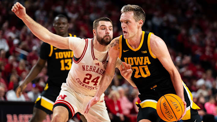 Mar 9, 2025; Lincoln, Nebraska, USA; Iowa Hawkeyes forward Payton Sandfort (20) drives against Nebraska Cornhuskers guard Rollie Worster (24) during the second half at Pinnacle Bank Arena. Mandatory Credit: Dylan Widger-Imagn Images Mar 9, 2025; Lincoln, Nebraska, USA; Iowa Hawkeyes forward Payton Sandfort (20) drives against Nebraska Cornhuskers guard Rollie Worster (24) during the second half at Pinnacle Bank Arena. Mandatory Credit: Dylan Widger-Imagn Images