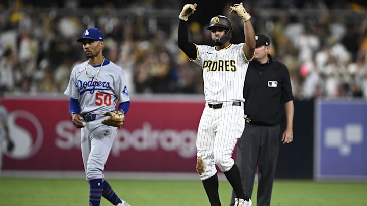 Aug 23, 2025; San Diego, California, USA; San Diego Padres shortstop Xander Bogaerts (2) celebrates after he hit an RBI double as Los Angeles Dodgers shortstop Mookie Betts (50) looks on during the eighth inning at Petco Park. Mandatory Credit: Denis Poroy-Imagn Images