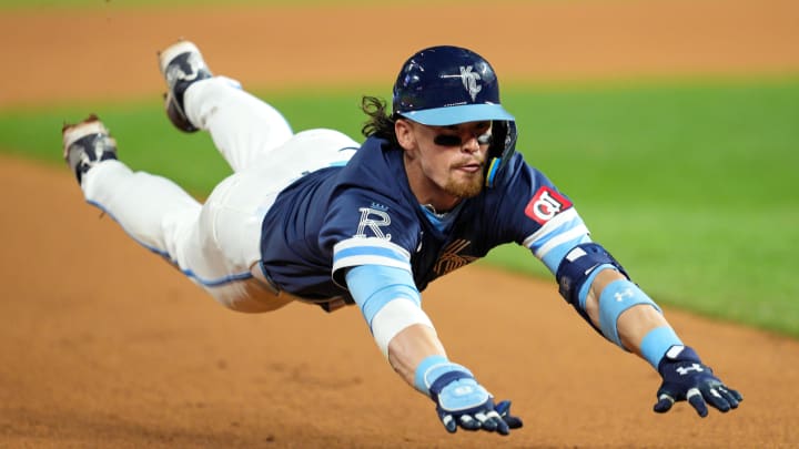 Jun 7, 2024; Kansas City, Missouri, USA; Kansas City Royals shortstop Bobby Witt Jr. (7) slides into third base for a triple during the ninth inning against the Seattle Mariners at Kauffman Stadium. 