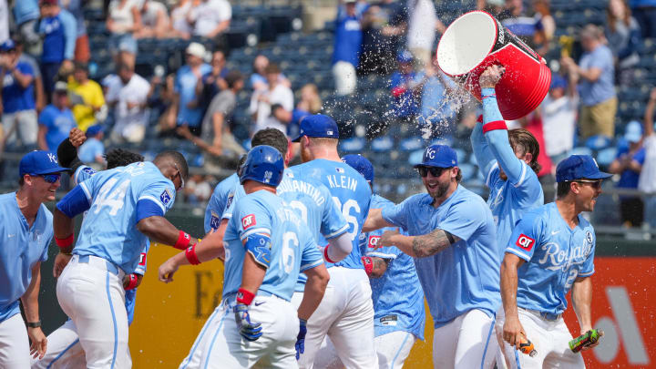 Jun 2, 2024; Kansas City, Missouri, USA; Kansas City Royals second baseman Nick Loftin (12) is doused by shortstop Bobby Witt Jr. (7) after hitting a walk off one-run sacrifice against the San Diego Padres in the ninth inning at Kauffman Stadium. Mandatory Credit: Denny Medley-USA TODAY Sports