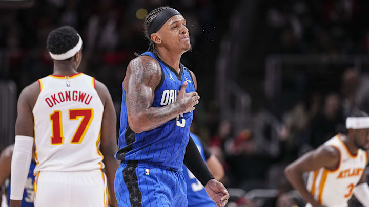 Orlando Magic forward Paolo Banchero (5) reacts after making a three-point basket late in the game against the Atlanta Hawks during the second half at State Farm Arena. Orlando Magic forward Paolo Banchero (5) reacts after making a three-point basket late in the game against the Atlanta Hawks during the second half at State Farm Arena.