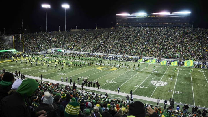 Nov 24, 2023; Eugene, Oregon, USA; Oregon Ducks fans cheer as the Ducks football team take the field before a game against the Oregon State Beavers at Autzen Stadium. Nov 24, 2023; Eugene, Oregon, USA; Oregon Ducks fans cheer as the Ducks football team take the field before a game against the Oregon State Beavers at Autzen Stadium.