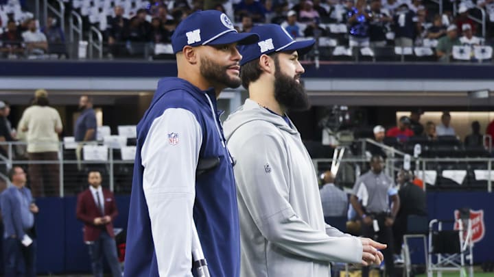 Nov 18, 2024; Arlington, Texas, USA;  Dallas Cowboys quarterback Dak Prescott (left) stands on crutches before the game against the Houston Texans at AT&T Stadium. Mandatory Credit: Kevin Jairaj-Imagn Images