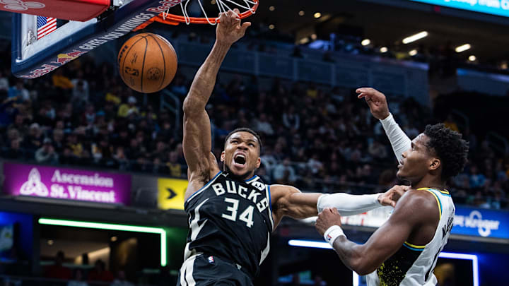 Dec 31, 2024; Indianapolis, Indiana, USA; Milwaukee Bucks forward Giannis Antetokounmpo (34) shoots the ball while Indiana Pacers guard Bennedict Mathurin (00) defends in the second half at Gainbridge Fieldhouse. Mandatory Credit: Trevor Ruszkowski-Imagn Images