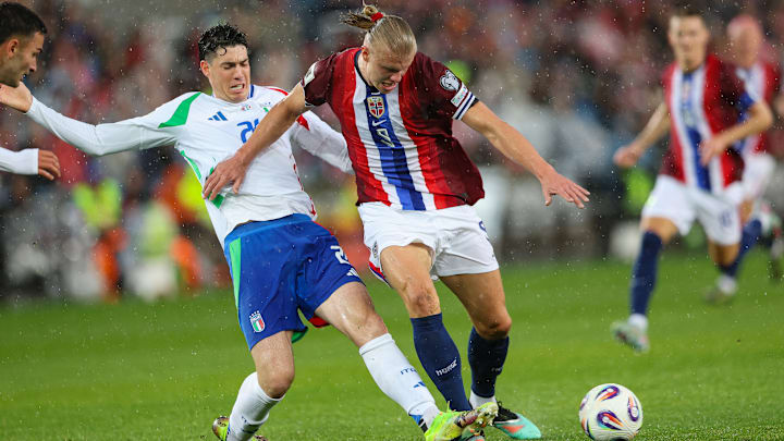 Alessandro Bastoni of Italy (L) and Erling Haaland of Norway...