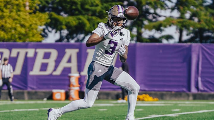 Rashid Williams catches a spring football pass, showing off his soft hands.