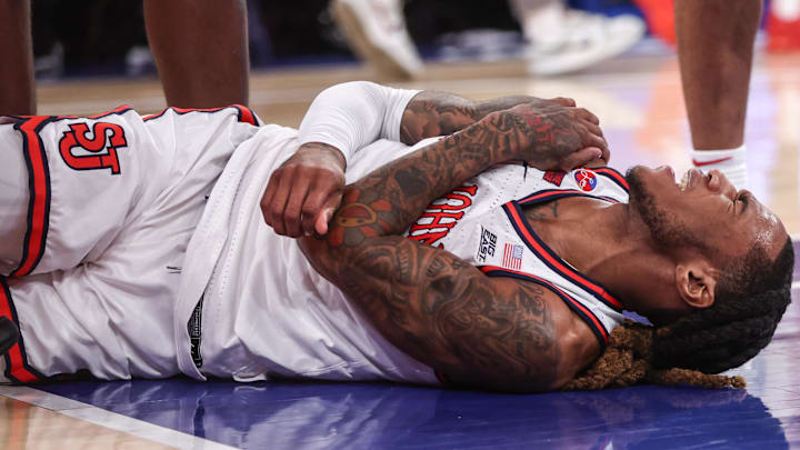 Jan 11, 2025; New York, New York, USA;  St. John's basketball guard Deivon Smith (5) reacts after suffering an apparent injury to his shoulder in the first half against the Villanova Wildcats at Madison Square Garden. 