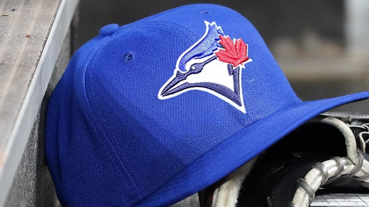 Apr 16, 2025; Toronto, Ontario, CAN; A Toronto Blue Jays hat and glove in the dugout during a game against the Atlanta Braves at Rogers Centre. 