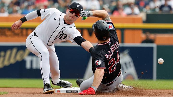Aug 13, 2026; Detroit, Michigan, USA;  Cleveland Guardians right fielder Chase DeLauter (24) steals second in the first inning as Detroit Tigers shortstop Kevin McGonigle (7) misses the throw at Comerica Park. Mandatory Credit: Rick Osentoski-Imagn Images