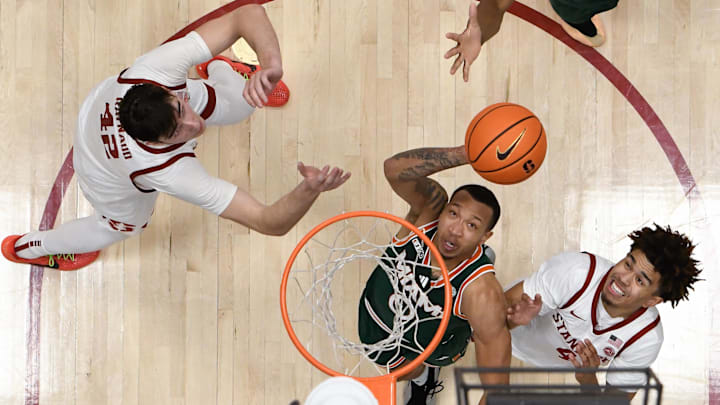 Jan 22, 2025; Stanford, California, USA; Miami (FL) Hurricanes guard Matthew Cleveland (0) attempts a basket against Stanford Cardinal guard Oziyah Sellers (4) and forward Maxime Raynaud (42) in the second half at Maples Pavilion. Mandatory Credit: Eakin Howard-Imagn Images Jan 22, 2025; Stanford, California, USA; Miami (FL) Hurricanes guard Matthew Cleveland (0) attempts a basket against Stanford Cardinal guard Oziyah Sellers (4) and forward Maxime Raynaud (42) in the second half at Maples Pavilion. Mandatory Credit: Eakin Howard-Imagn Images