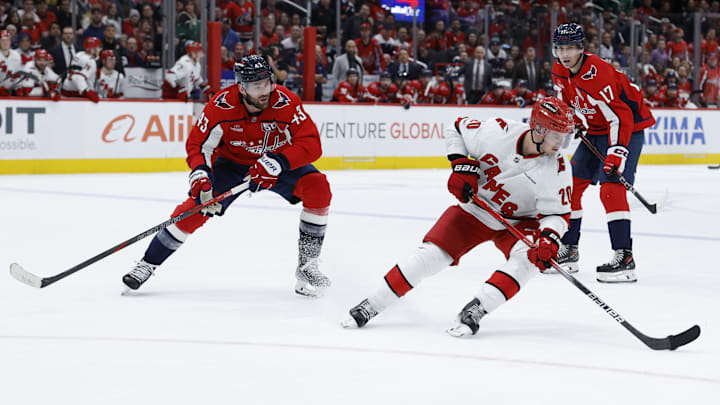 Apr 10, 2025; Washington, District of Columbia, USA; Carolina Hurricanes center Sebastian Aho (20) skates with the puck as Washington Capitals right wing Tom Wilson (43) chases in the third period at Capital One Arena. Mandatory Credit: Geoff Burke-Imagn Images