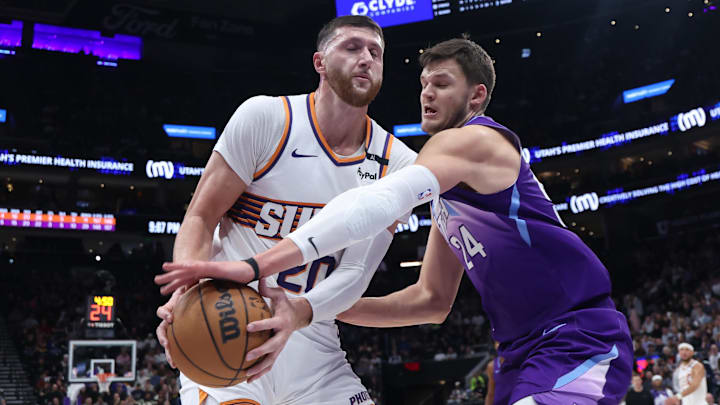 Dec 13, 2024; Salt Lake City, Utah, USA; Phoenix Suns center Jusuf Nurkic (20) and Utah Jazz center Walker Kessler (24) play for a loose ball during the third quarter at Delta Center. Mandatory Credit: Rob Gray-Imagn Images
