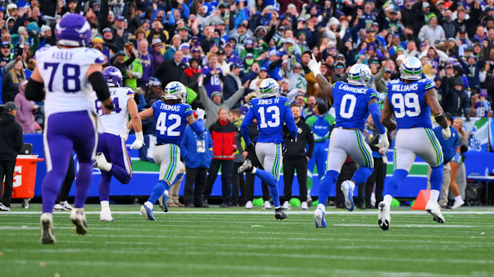 Nov 30, 2025; Seattle, Washington, USA; Seattle Seahawks linebacker Ernest Jones IV (13) runs back for an interception during the first half against the Minnesota Vikings at Lumen Field. Mandatory Credit: Steven Bisig-Imagn Images