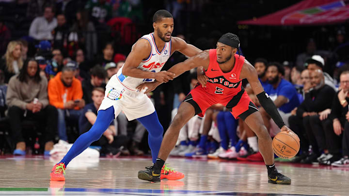 Feb 11, 2025; Philadelphia, Pennsylvania, USA; Toronto Raptors guard Immanuel Quickley (5) controls the ball against Philadelphia 76ers guard Jared Butler (12) in the second quarter at Wells Fargo Center. Mandatory Credit: Kyle Ross-Imagn Images