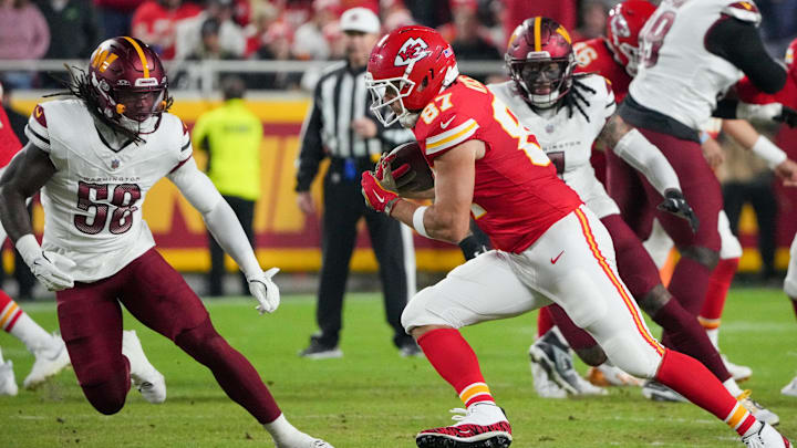 Oct 27, 2025; Kansas City, Missouri, USA; Kansas City Chiefs tight end Travis Kelce (87) carries the ball defended by Washington Commanders linebacker Jordan Magee (58) during the second quarter of the game at GEHA Field at Arrowhead Stadium. Mandatory Credit: Denny Medley-Imagn Images