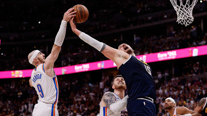 May 11, 2025; Denver, Colorado, USA; Oklahoma City Thunder guard Alex Caruso (9) and Denver Nuggets center Nikola Jokic (15) battle for a rebound as center Isaiah Hartenstein (55) defends in the fourth quarter during game four of the second round of the 2025 NBA Playoffs at Ball Arena.