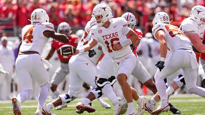 Texas Longhorns quarterback Arch Manning hands off to running back CJ Baxter against the Ohio State Buckeyes. Texas Longhorns quarterback Arch Manning hands off to running back CJ Baxter against the Ohio State Buckeyes.