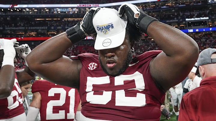 Dec 2, 2023; Atlanta, GA, USA;  Alabama Crimson Tide offensive lineman Tyler Booker (52) wears an SEC Championship hat at Mercedes-Benz Stadium. Alabama defeated Georgia 27-24 to claim the SEC Championship. Mandatory Credit: Gary Cosby Jr.-Imagn Images