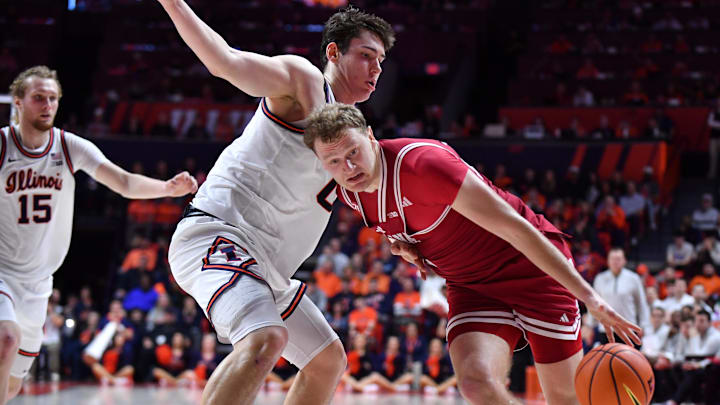 Feb 15, 2026; Champaign, Illinois, USA; Indiana Hoosiers forward Tucker DeVries (12) drives the ball against Illinois Fighting Illini forward David Mirkovic (0) during the second half at State Farm Center. Mandatory Credit: Ron Johnson-Imagn Images Feb 15, 2026; Champaign, Illinois, USA; Indiana Hoosiers forward Tucker DeVries (12) drives the ball against Illinois Fighting Illini forward David Mirkovic (0) during the second half at State Farm Center. Mandatory Credit: Ron Johnson-Imagn Images