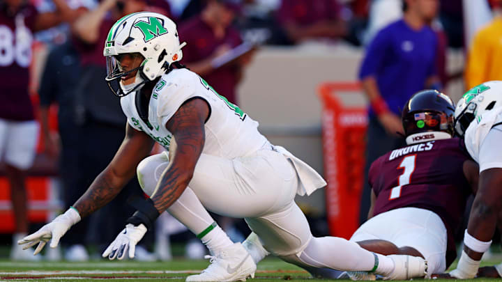 Sep 7, 2024; Blacksburg, Virginia, USA; Marshall Thundering Herd defensive lineman Mike Green (15) celebrates after sacking Virginia Tech Hokies quarterback Kyron Drones (1) during the first quarter at Lane Stadium.  