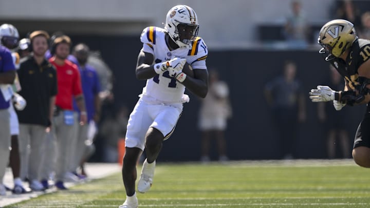 Oct 18, 2025; Nashville, Tennessee, USA;  Louisiana State Tigers tight end Trey'Dez Green (14) runs with the ball after a made catch against the Vanderbilt Commodores during the first half at FirstBank Stadium. Mandatory Credit: Steve Roberts-Imagn Images
