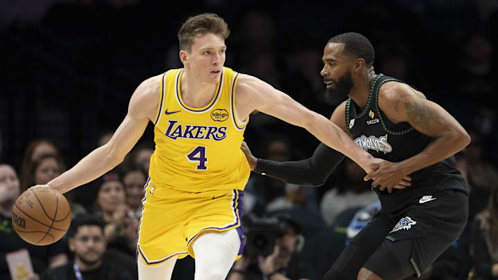 Oct 29, 2025; Minneapolis, Minnesota, USA; Los Angeles Lakers forward Dalton Knecht (4) dribbles the ball as Minnesota Timberwolves guard Mike Conley (10) plays defense in the first half at Target Center. Mandatory Credit: Jesse Johnson-Imagn Images Oct 29, 2025; Minneapolis, Minnesota, USA; Los Angeles Lakers forward Dalton Knecht (4) dribbles the ball as Minnesota Timberwolves guard Mike Conley (10) plays defense in the first half at Target Center. Mandatory Credit: Jesse Johnson-Imagn Images