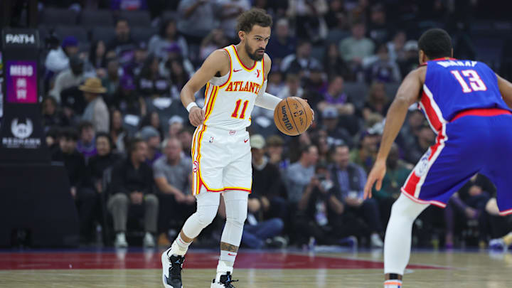 Nov 18, 2024; Sacramento, California, USA; Atlanta Hawks guard Trae Young (11) dribbles the ball against Sacramento Kings forward Keegan Murray (13) during the first quarter at Golden 1 Center. Mandatory Credit: Sergio Estrada-Imagn Images