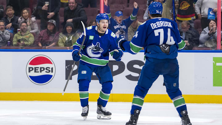 Nov 16, 2024; Vancouver, British Columbia, CAN; Vancouver Canucks defenseman Erik Brannstrom (26) and forward Jake DeBrusk (74) celebrate Brannstrom’s goal against the Chicago Blackhawks during the third period at Rogers Arena. Mandatory Credit: Bob Frid-Imagn Images
