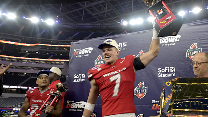 Dec 18, 2024; Inglewood, CA, USA;    RUNLV Rebels linebacker Jackson Woodard (7) holds his defensive player of the game trophy as wide receiver Jacob De Jesus (21) was named offensive player of the game after defeating the California Golden Bears in the LA Bowl at SoFi Stadium. Mandatory Credit: Jayne Kamin-Oncea-Imagn Images