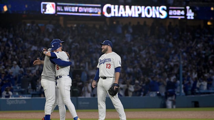 Sep 26, 2024; Los Angeles, California, USA;  Los Angeles Dodgers left fielder Teoscar Hernandez (37), third baseman Enrique Hernandez (8) and third baseman Max Muncy (13) after clinching the National League West by defeating the San Diego Padres 7-2 at Dodger Stadium. 