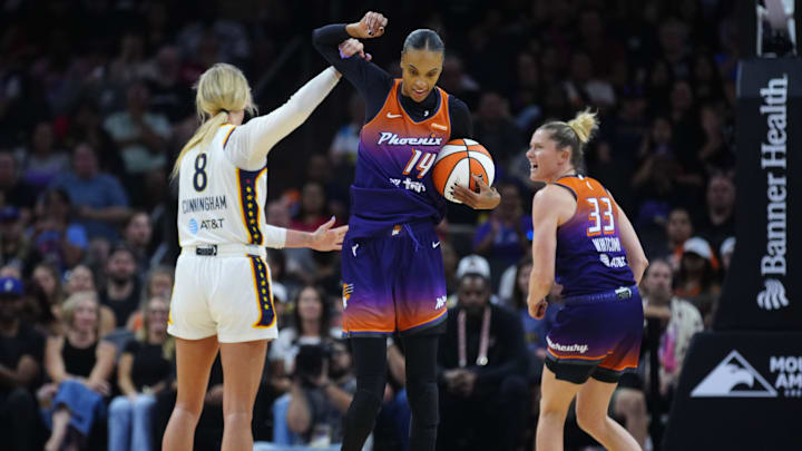 Fever guard Sophie Cunningham fouls Mercury guard DeWanna Bonner (14) during a game at PHX Arena in Phoenix on Aug. 7, 2025.