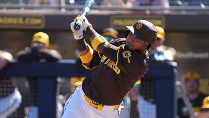 Feb 25, 2025; Peoria, Arizona, USA; San Diego Padres first base Luis Arraez (4) bats against the Los Angeles Angels during the first inning at Peoria Sports Complex. 
