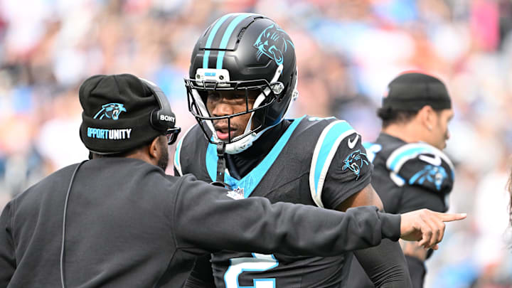 Dec 21, 2025; Charlotte, North Carolina, USA; Carolina Panthers cornerback Mike Jackson (2) talks to an assistant coach in the second quarter at Bank of America Stadium. Mandatory Credit: Bob Donnan-Imagn Images