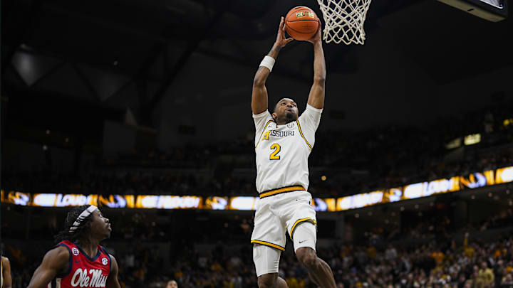 Jan 25, 2025; Columbia, Missouri, USA; Missouri Tigers guard Tamar Bates (2) dunks the ball against Mississippi Rebels guard Jaylen Murray (5) during the first half at Mizzou Arena. Mandatory Credit: Jay Biggerstaff-Imagn Images Jan 25, 2025; Columbia, Missouri, USA; Missouri Tigers guard Tamar Bates (2) dunks the ball against Mississippi Rebels guard Jaylen Murray (5) during the first half at Mizzou Arena. Mandatory Credit: Jay Biggerstaff-Imagn Images