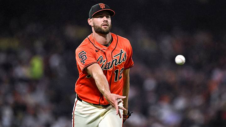 Jun 26, 2026; San Francisco, California, USA; San Francisco Giants pitcher Adrian Houser (12) tosses the ball to first base for an out during the top of the eighth inning against the Atlanta Braves at Oracle Park. Mandatory Credit: Justine Willard-Imagn Images