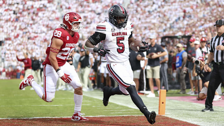 Oct 19, 2024; Norman, Oklahoma, USA; South Carolina Gamecocks running back Raheim Sanders (5) scores a touchdown past Oklahoma Sooners linebacker Danny Stutsman (28) during the first half at Gaylord Family-Oklahoma Memorial Stadium. Mandatory Credit: Kevin Jairaj-Imagn Images Oct 19, 2024; Norman, Oklahoma, USA; South Carolina Gamecocks running back Raheim Sanders (5) scores a touchdown past Oklahoma Sooners linebacker Danny Stutsman (28) during the first half at Gaylord Family-Oklahoma Memorial Stadium. Mandatory Credit: Kevin Jairaj-Imagn Images