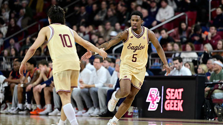 Jan 31, 2026; Chestnut Hill, Massachusetts, USA; Boston College Eagles guard Fred Payne (5) reacts to his basket against the Virginia Cavaliers with guard Luka Toews (10) during the first half at Conte Forum. Mandatory Credit: Eric Canha-Imagn Images