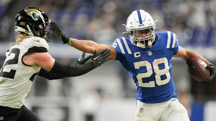 Indianapolis Colts running back Jonathan Taylor (28) pushes off Jacksonville Jaguars safety Andrew Wingard (42) as he rushes the ball Sunday, Jan. 5, 2025, during a game against the Jacksonville Jaguars at Lucas Oil Stadium in Indianapolis.