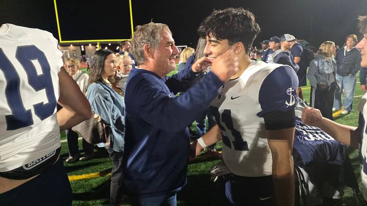 Lake Oswego coach Steve Coury celebrates with one of his players after capturing his 300th career win on Friday. Lake Oswego coach Steve Coury celebrates with one of his players after capturing his 300th career win on Friday.