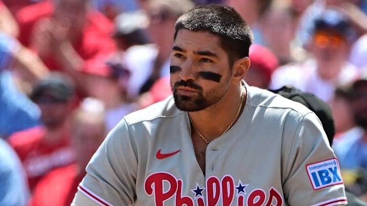 Apr 13, 2025; St. Louis, Missouri, USA; Philadelphia Phillies outfielder Nick Castellanos (8) removes an elbow guard after striking out against the St. Louis Cardinals at Busch Stadium