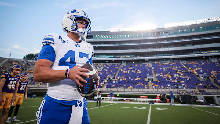 BYU quarterback Bear Bachmeier warms up against East Carolina